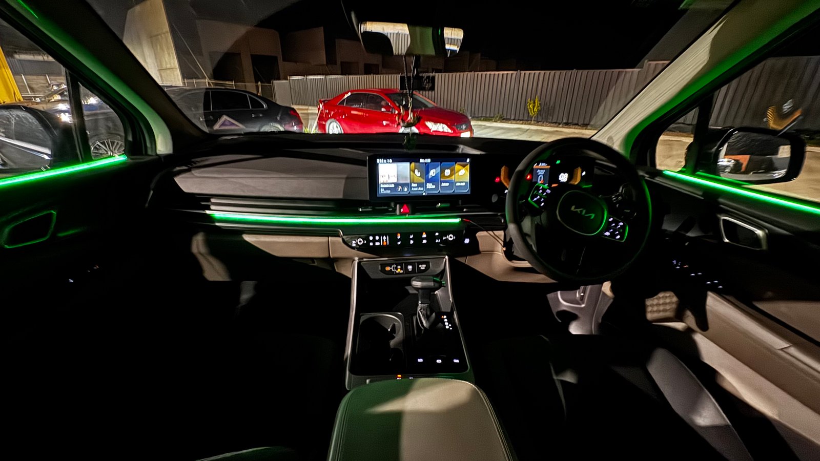 Custom ambient lighting install — green accent strips in a Kia interior
